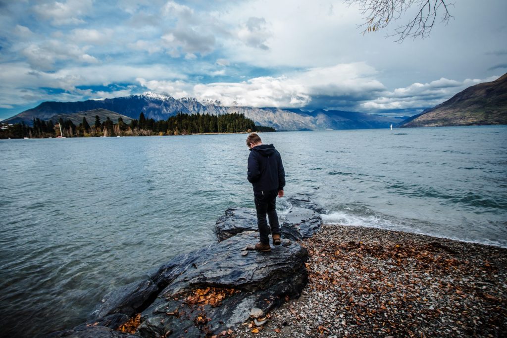 Man standing in front of lake representing sex therapy for men