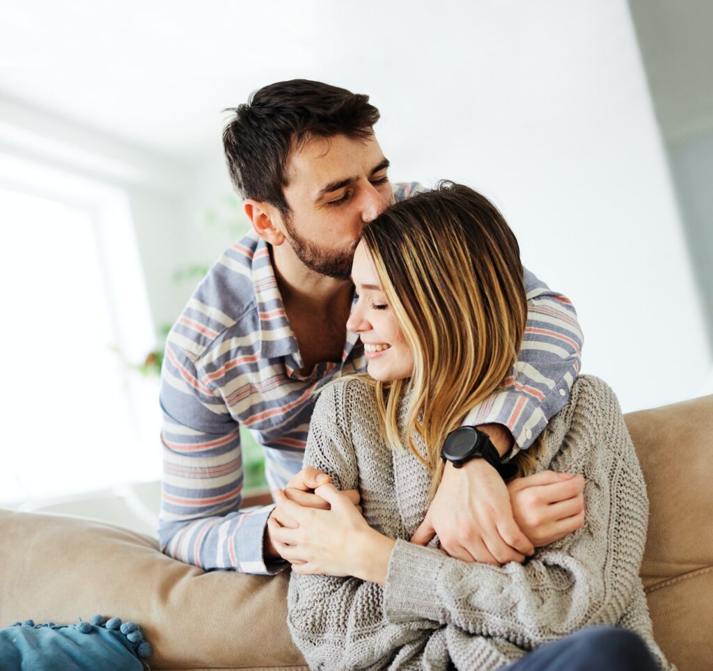 couple love sofa home hug romance