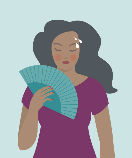 Woman with a fan, hot flashes, menopause symptoms.