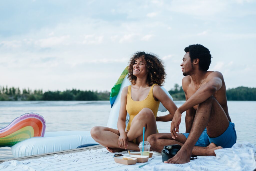 Two people sitting together in warm summer light, representing a relationship reset and deep emotional connection.
